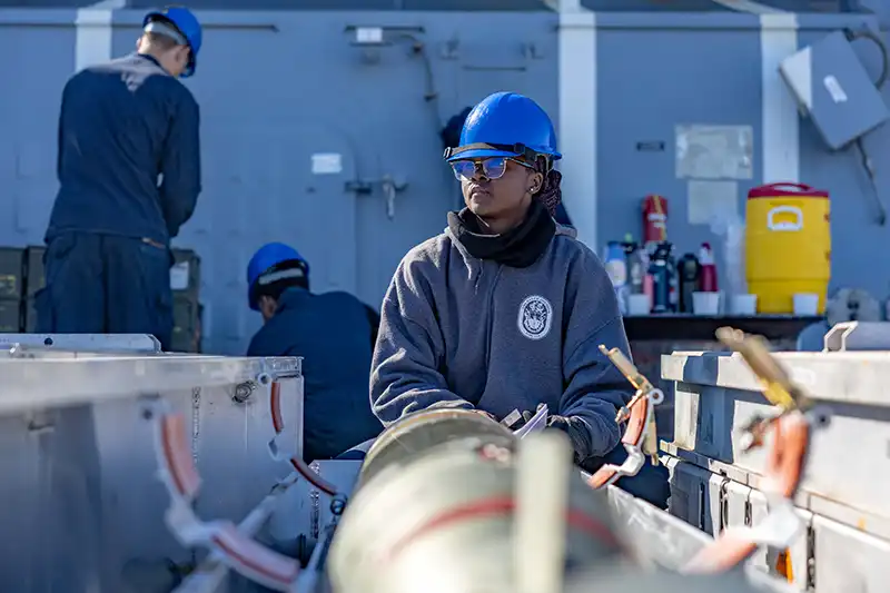 Houston native inspects a torpedo aboard USS Ralph Johnson